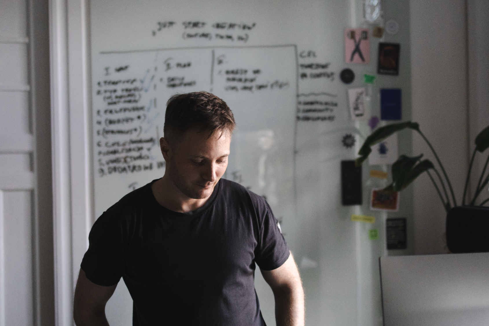 Przemek working in front of a whiteboard during a workshop.